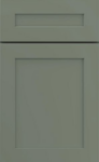 Shaker-style cabinet door in sage green with simple, clean lines. The door has a rectangular panel design, conveying a modern and minimalist feel.